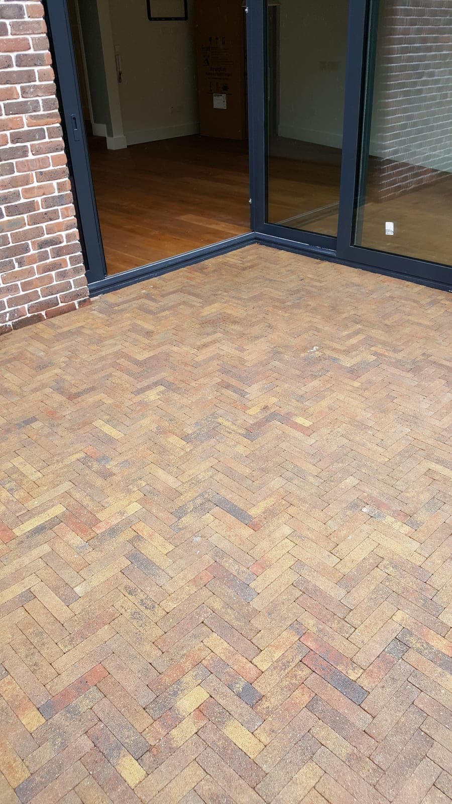 Herringbone brick patio laid outside the new glazing