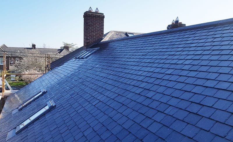 Natural slate roof with rooflights being completed