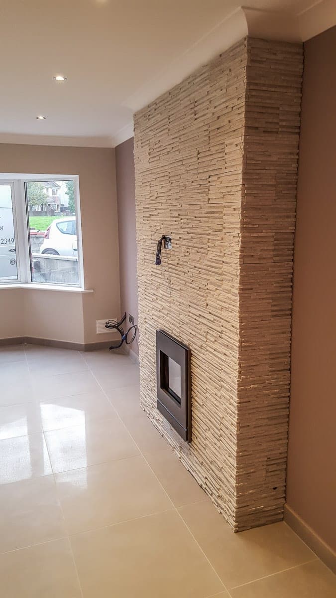Living room with a stone feature wall and polished tile floor