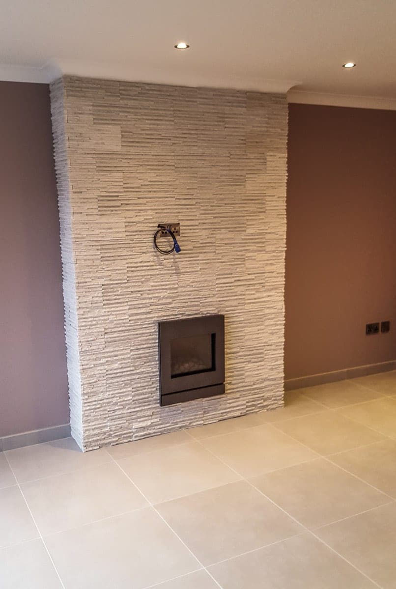 Stone-clad chimney breast with an inset fire