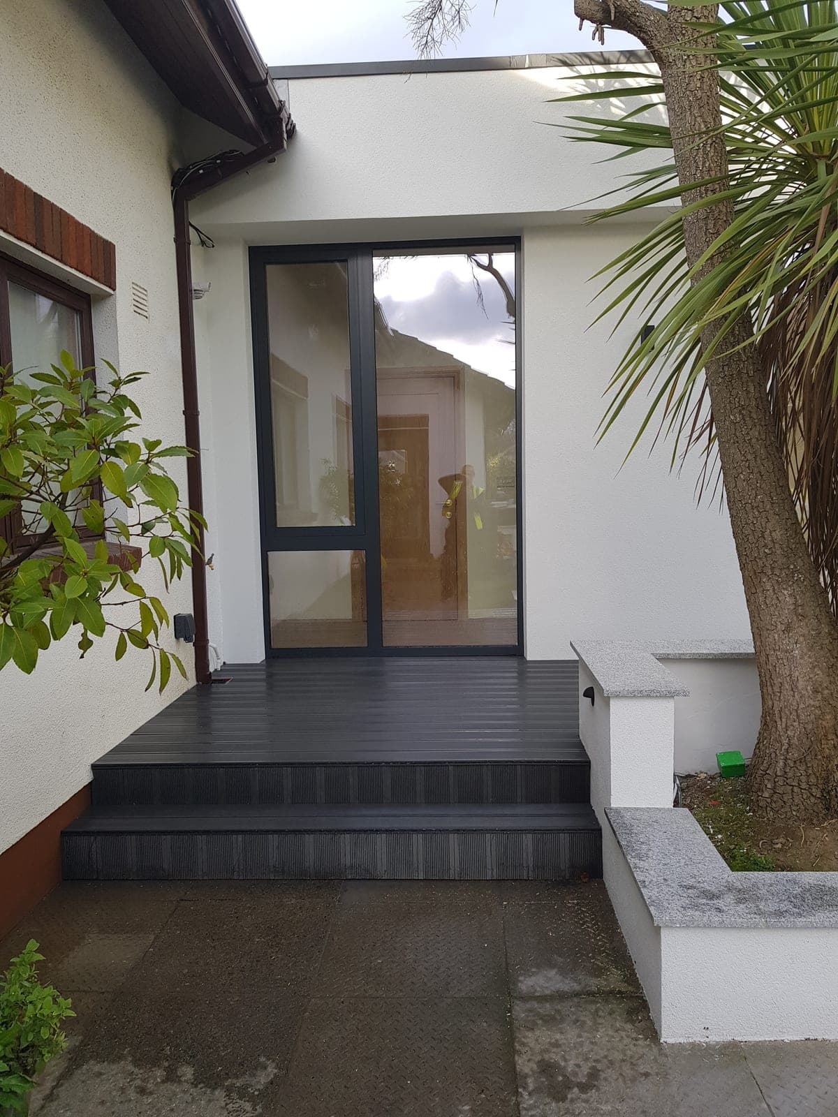 Glazed side entrance reached by decked steps
