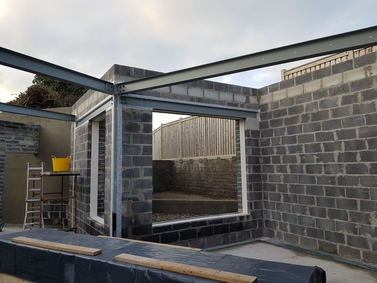 Steel beams set over the blockwork walls
