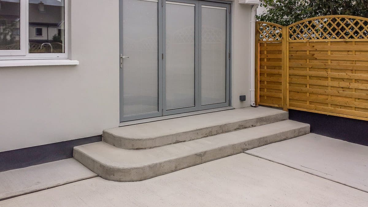 Bifold doors with curved concrete steps to the garden
