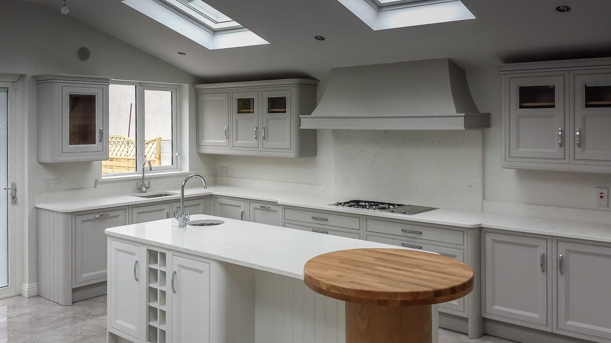 Shaker kitchen island with a round oak breakfast table